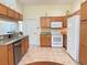 Well-equipped kitchen featuring granite countertops, stainless steel appliances, and ample storage at 9348 Villa Entrada, New Port Richey, FL 34655