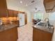 Well-lit kitchen with granite countertops, stainless steel sink, and cozy breakfast nook at 9348 Villa Entrada, New Port Richey, FL 34655