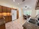 Spacious kitchen with granite countertops, tiled floor, and adjacent dining area at 9348 Villa Entrada, New Port Richey, FL 34655