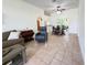 Open-concept living room showcasing tile floors, modern furnishings, and dining area access at 9348 Villa Entrada, New Port Richey, FL 34655