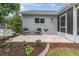 Charming outdoor patio with a decorative concrete pad, quaint seating, and beautiful landscaping at 9348 Villa Entrada, New Port Richey, FL 34655
