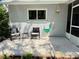 Charming outdoor patio with a decorative concrete pad, quaint seating, and beautiful landscaping at 9348 Villa Entrada, New Port Richey, FL 34655