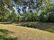 Lush backyard with green lawn and scenic water view, creating a peaceful and private setting at 9348 Villa Entrada, New Port Richey, FL 34655