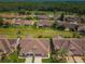 Expansive aerial view showcases the community's lush greenery and well-maintained homes in a park-like setting at 9636 Brookdale Dr, New Port Richey, FL 34655