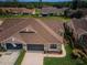 An aerial view that shows a well-maintained home featuring brown trim and a lush, green yard at 9636 Brookdale Dr, New Port Richey, FL 34655