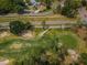 Aerial view showcasing the verdant golf course, mature trees, and residential surroundings at 9636 Brookdale Dr, New Port Richey, FL 34655