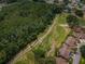 Aerial view of a golf course community surrounded by lush greenery at 9636 Brookdale Dr, New Port Richey, FL 34655