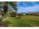 Spacious backyard featuring lush green grass and mature landscaping at 9636 Brookdale Dr, New Port Richey, FL 34655