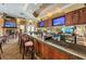 Community bar with multiple televisions, varied liquor selection, and a cozy fireplace at 9636 Brookdale Dr, New Port Richey, FL 34655