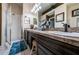 Bathroom with dark wood cabinets, dual sinks, lots of counter space, a walk-in shower and decorative touches at 9636 Brookdale Dr, New Port Richey, FL 34655