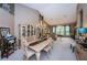 Open-concept dining area featuring a chandelier and views into the living area at 9636 Brookdale Dr, New Port Richey, FL 34655
