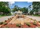 The entrance to Timber Greens has a waterfall feature, plants, and signage at 9636 Brookdale Dr, New Port Richey, FL 34655