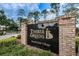 Timber Greens Royale Oak Village entrance sign with brick accents and well-maintained landscaping at 9636 Brookdale Dr, New Port Richey, FL 34655