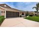 Attractive home featuring an attached two-car garage with brown trim and a well-manicured front lawn at 9636 Brookdale Dr, New Port Richey, FL 34655