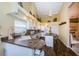 Bright kitchen with white cabinetry, wood floors, modern appliances, and a functional island at 9636 Brookdale Dr, New Port Richey, FL 34655