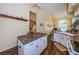 Kitchen with wood-look flooring, island seating, and a view to the living room at 9636 Brookdale Dr, New Port Richey, FL 34655