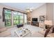 Open-concept living room featuring large windows, a ceiling fan, and neutral decor at 9636 Brookdale Dr, New Port Richey, FL 34655