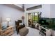 Relaxing sitting area in main bedroom offers a comfortable chair, TV, and serene view of the enclosed patio at 9636 Brookdale Dr, New Port Richey, FL 34655