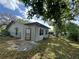 The backyard has a chain link fence, a patio, and a neutral exterior paint color at 10619 Mira Vista Dr, Port Richey, FL 34668
