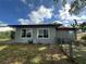 This home's backyard features a chain link fence and a neutral exterior paint color at 10619 Mira Vista Dr, Port Richey, FL 34668