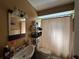 Bathroom with vanity sink, mirror, and shower/tub with curtain at 10619 Mira Vista Dr, Port Richey, FL 34668