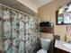 This is a cozy bathroom featuring a toilet, a shower curtain, and some storage at 10619 Mira Vista Dr, Port Richey, FL 34668
