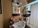 Bathroom with vanity sink, mirror, and shower/tub with curtain at 10619 Mira Vista Dr, Port Richey, FL 34668