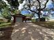 Charming home with a red brick facade, attached garage, and a screened-in porch at 10619 Mira Vista Dr, Port Richey, FL 34668