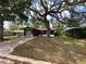 Cozy home with mature trees shading the front yard and driveway at 10619 Mira Vista Dr, Port Richey, FL 34668