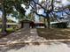 Cozy home with mature trees shading the front yard and driveway at 10619 Mira Vista Dr, Port Richey, FL 34668