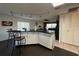 The kitchen features white cabinets, an island with seating, and an open living space at 10619 Mira Vista Dr, Port Richey, FL 34668