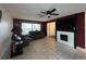 Comfortable living room boasts a fireplace, ceiling fan, and a large window at 10619 Mira Vista Dr, Port Richey, FL 34668