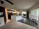 Open-concept living space features tile floors, a cozy fireplace, and a modern kitchen with a breakfast bar at 10619 Mira Vista Dr, Port Richey, FL 34668