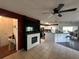 Spacious living room features a fireplace and opening up into the kitchen at 10619 Mira Vista Dr, Port Richey, FL 34668