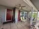 Inviting front porch with outdoor seating, ceiling fans, and charming brick accents create a welcoming entrance at 10619 Mira Vista Dr, Port Richey, FL 34668