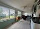 Bright sunroom with large windows and a dining area at 10619 Mira Vista Dr, Port Richey, FL 34668