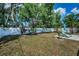 Spacious backyard with privacy fence, lounge chairs and a concrete patio, perfect for outdoor relaxation at 1074 Woodbrook S Dr, Largo, FL 33770