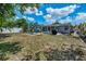 Spacious backyard features a patio, perfect for entertaining, with a lush green lawn at 1074 Woodbrook S Dr, Largo, FL 33770