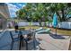 Backyard features patio, lounge chairs, dining set, and lush greenery for outdoor enjoyment at 1074 Woodbrook S Dr, Largo, FL 33770