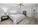 Comfortable bedroom featuring a patterned bedspread, ceiling fan, and ample natural light at 1074 Woodbrook S Dr, Largo, FL 33770