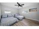 Bedroom showcasing two beds, wood-look flooring, and a ceiling fan at 1074 Woodbrook S Dr, Largo, FL 33770