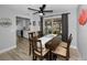 Bright dining room with a ceiling fan, sliding glass doors to the lanai, and seating for six at 1074 Woodbrook S Dr, Largo, FL 33770
