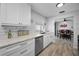 Bright kitchen featuring white cabinets, stainless steel appliances and subway tile backsplash at 1074 Woodbrook S Dr, Largo, FL 33770