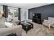 Inviting living room with a comfortable couch, glass coffee table, and stylish decor at 1074 Woodbrook S Dr, Largo, FL 33770