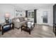 Comfortable living room features neutral tones, a large window for natural light, and sleek wood-look tile floors at 1074 Woodbrook S Dr, Largo, FL 33770