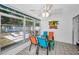 Bright enclosed patio with tile floors, ceiling fan, and views of the outdoor seating area at 1074 Woodbrook S Dr, Largo, FL 33770