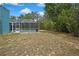 Spacious backyard featuring a large screened-in pool, perfect for outdoor entertaining at 11379 Flower Ave, Weeki Wachee, FL 34613