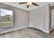 Bedroom with ceiling fan, closet, one window, and wood-look flooring at 11379 Flower Ave, Weeki Wachee, FL 34613