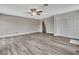 Bedroom features wood-look floors, neutral paint, and large closet at 11379 Flower Ave, Weeki Wachee, FL 34613