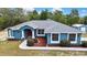 Charming single Gathering home featuring a vibrant blue exterior, landscaped yard, and a welcoming front entrance at 11379 Flower Ave, Weeki Wachee, FL 34613